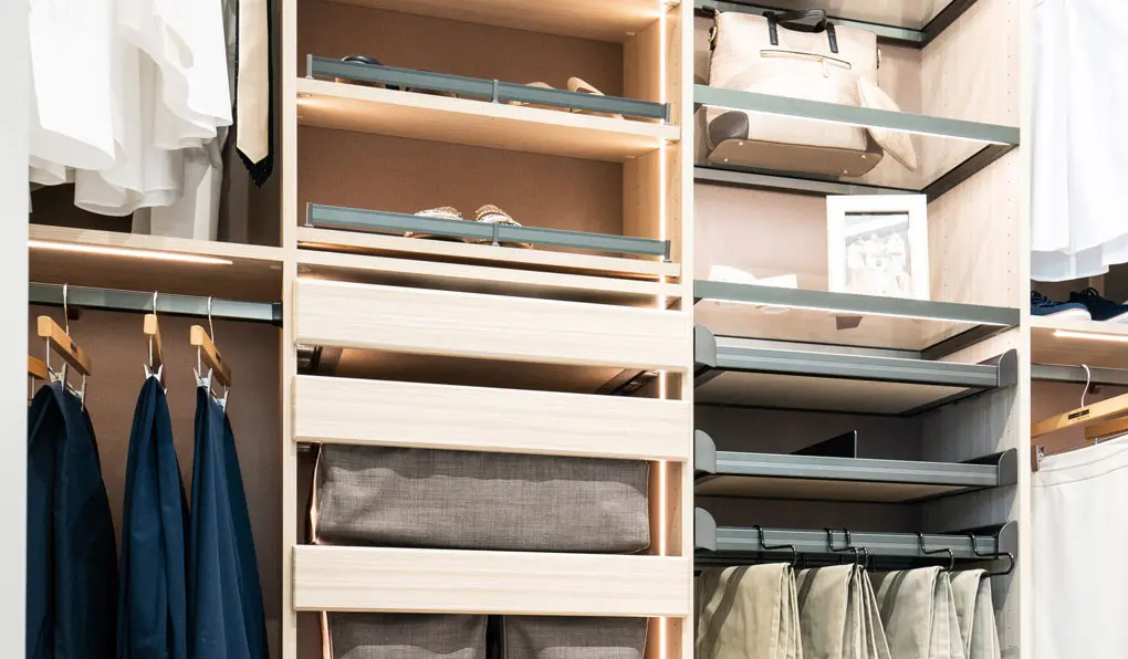 Light wood mens closet with glass shelves 