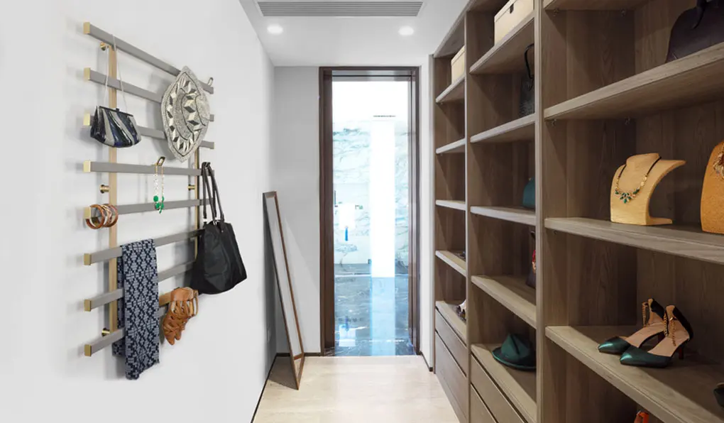 Closet with minimalistic brown wood shelves