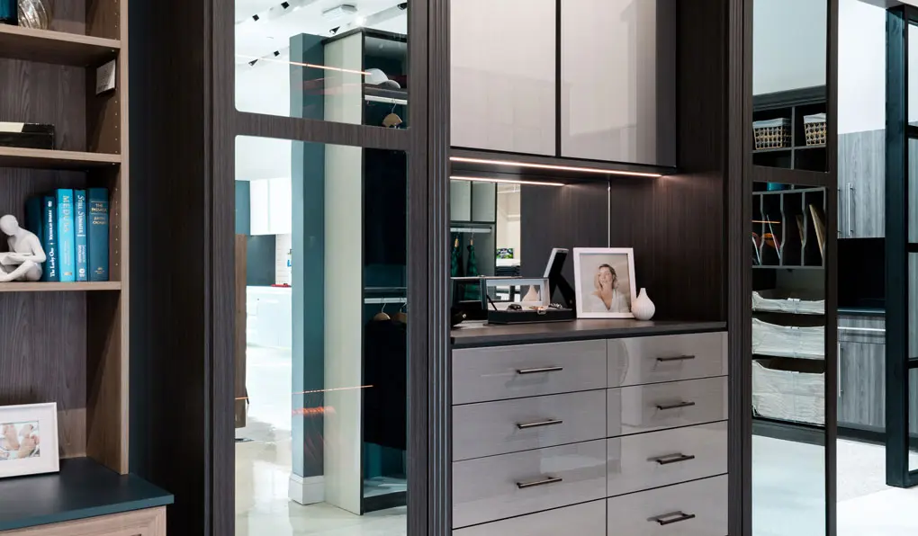 Dark wood closet with mirrored doors