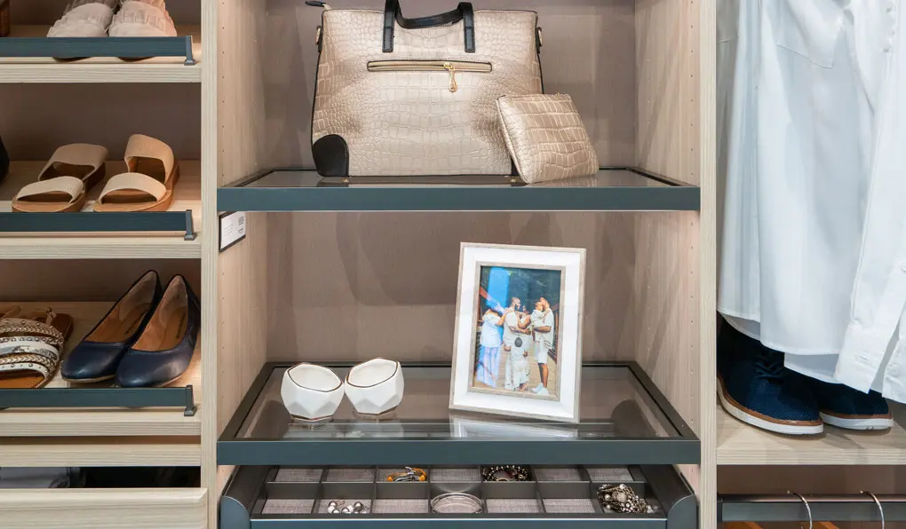 light beige wood custom closet with glass shelves