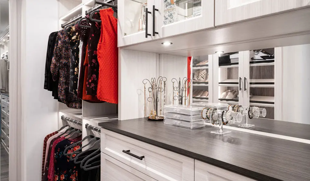 custom closet white shelves dark brown accent and black hardware