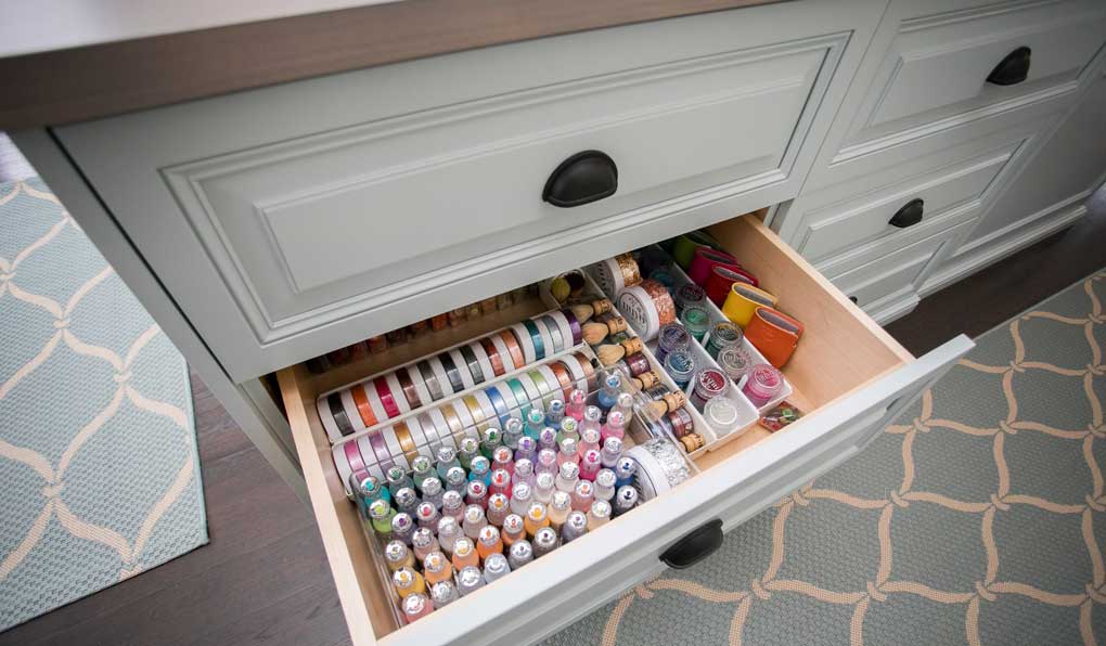 Custom craft and hobby room with royal classic raised panel drawer fronts and Hafele dark oil-rubbed bronze cup handles