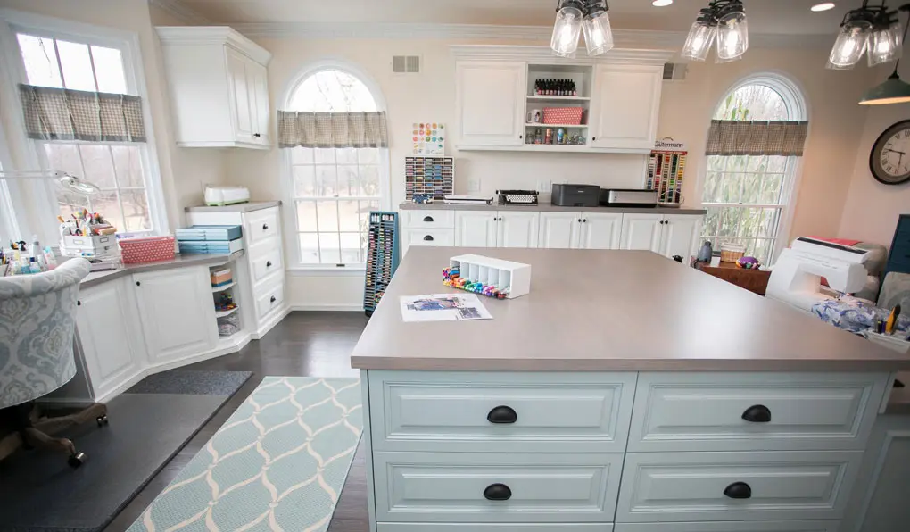 Craft room with custom storage and raised drawers in dark finish