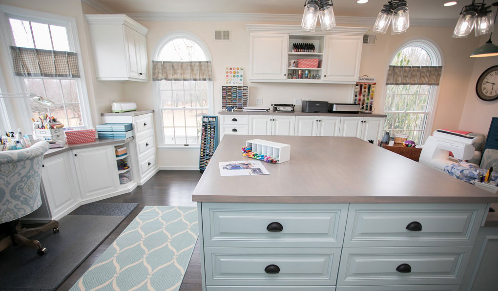 Craft room with custom storage and raised drawers in dark finish