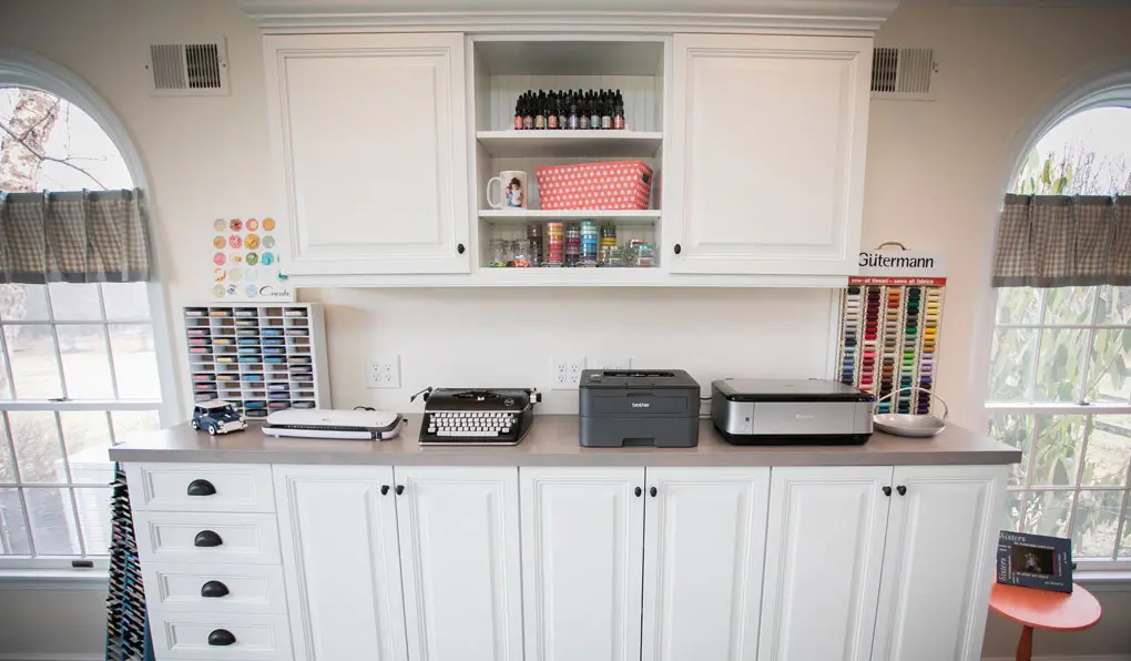 Custom craft and hobby room with white raised doors and dark oil-rubbed bronze hardware