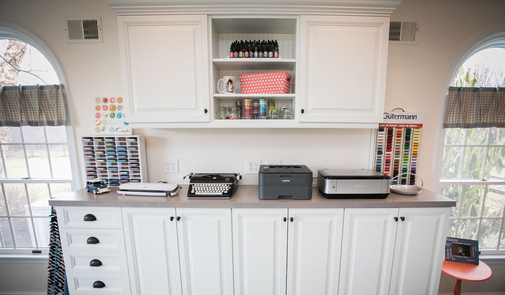 Custom craft and hobby room with white raised doors and dark oil-rubbed bronze hardware